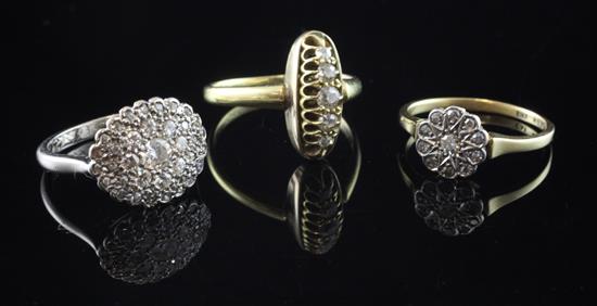 Two early 20th century 18ct gold and diamond cluster rings and one other gold and diamond ring with inscription to the shank,